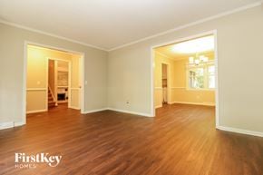 Summerville house for rent - A room with wooden floors and two open doors.