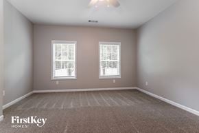Dacula house for rent - A room with two windows and a carpeted floor.