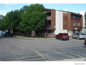 Prince Albert house for rent - a parking lot with cars in front of a building