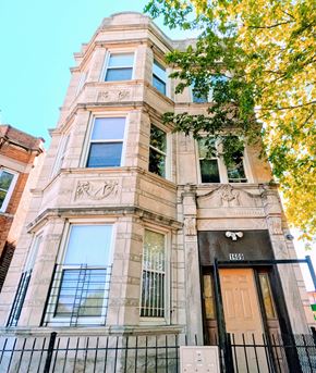 Chicago apartment for rent - a tall building with a tree in front of it