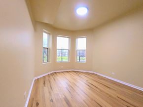 Chicago apartment for rent - an empty living room with wooden floors and windows