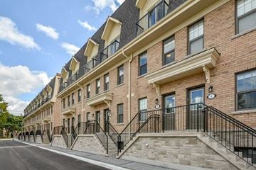 Guelph apartment for rent - a large brick building with stairs and a street in front