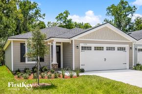 Jacksonville house for rent - a home with a white garage door and a lawn