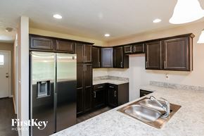 Jacksonville house for rent - a kitchen with stainless steel appliances and black cabinets