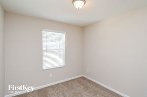 Jacksonville house for rent - a bedroom with beige carpet and a window