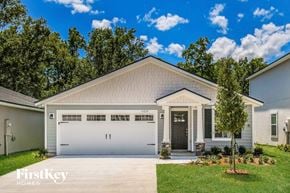 Jacksonville house for rent - a white house with a garage door and a lawn