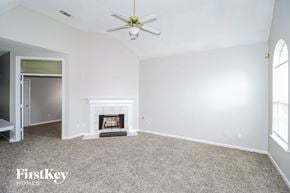 Memphis house for rent - a living room with a fireplace and a ceiling fan