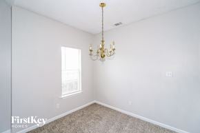 Memphis house for rent - a bedroom with a chandelier and white walls and a window