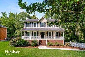 Alabaster house for rent - A house with a porch and a white picket fence.