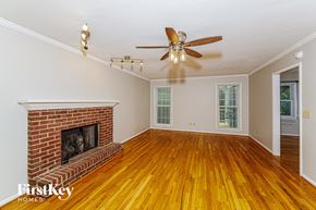 Alabaster house for rent - A room with a fireplace and wood floors.