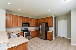 Orange Park house for rent - a kitchen with wooden cabinets and stainless steel appliances