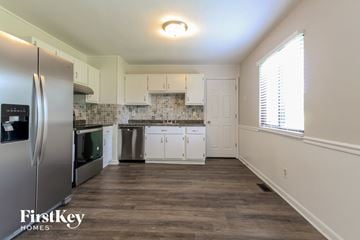 Indianapolis house for rent - a kitchen with white cabinets and stainless steel appliances