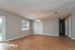 Apollo Beach house for rent - an empty living room with wood floors and a white door