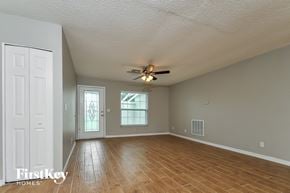 Apollo Beach house for rent - the living room and dining room with wood floors and a ceiling fan