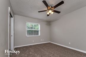 Apollo Beach house for rent - a bedroom with a ceiling fan and a window