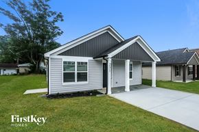 Kannapolis house for rent - the front of a white house with a sidewalk in front of it