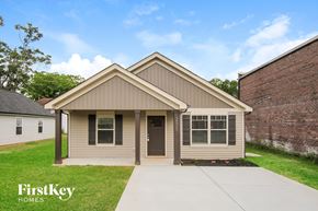 Kannapolis house for rent - a small brown house with a sidewalk in front of it