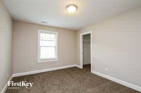 Kannapolis house for rent - a bedroom with carpet and a window and a door to a closet