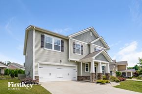Belmont house for rent - a beige house with a white garage door