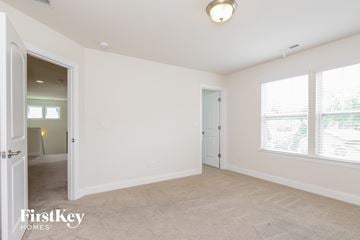 Belmont house for rent - the living room and dining room of a home with white walls and carpet