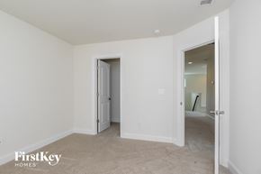 Belmont house for rent - a bedroom with white walls and a door to a hallway