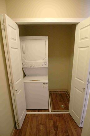 Saskatoon apartment for rent - A white dishwasher and dryer are stacked in a small space.