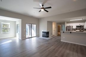 Annapolis house for rent - an empty living room and kitchen with a ceiling fan