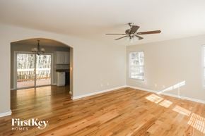 Kannapolis house for rent - a living room with wood floors and a ceiling fan