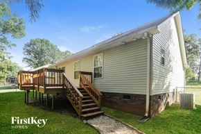 Kannapolis house for rent - the exterior of a tiny home with a deck and a staircase