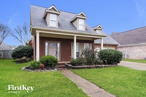 Collierville house for rent - a small brick house with a sidewalk in front of it