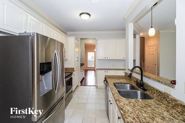 Collierville house for rent - a kitchen with granite counter tops and stainless steel appliances