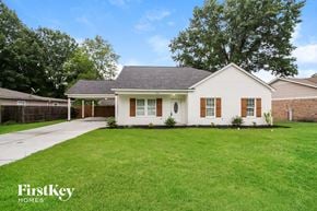 Memphis house for rent - a white house with a lawn and a driveway