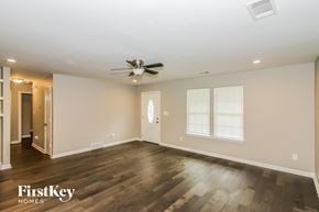 Memphis house for rent - the living room with wood flooring and a ceiling fan