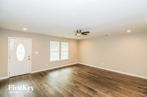 Memphis house for rent - the living room with hardwood floors and a ceiling fan