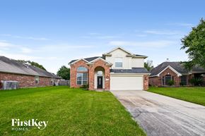 Baytown house for rent - a house with a driveway and a garage door