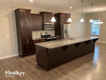 Locust house for rent - a kitchen with an island and dark wood cabinets
