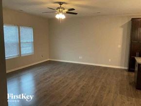 Locust house for rent - an empty living room with a ceiling fan and wood floors