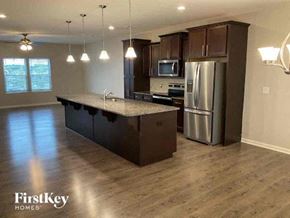 Locust house for rent - an empty kitchen with a stainless steel refrigerator