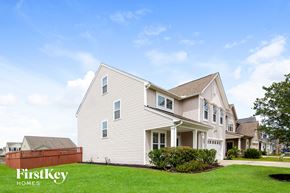 Moncks Corner house for rent - a white house with a yard and a fence
