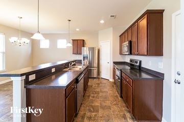 Moncks Corner house for rent - a kitchen with wooden cabinets and stainless steel appliances