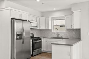 North Hollywood apartment for rent - a kitchen with stainless steel appliances and white cabinets