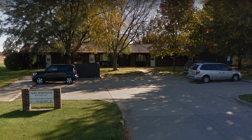 South English apartment for rent - a parking lot in front of a building with cars parked