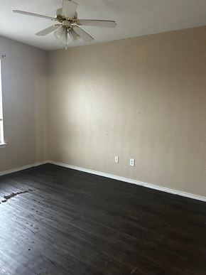 Killeen apartment for rent - A room with a ceiling fan and wooden flooring.