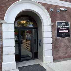 Winnipeg apartment for rent - a brick building with a glass door and a sign