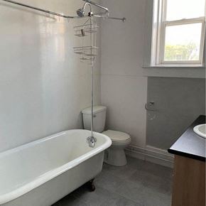 Winnipeg apartment for rent - a bathroom with a tub and a toilet and a sink
