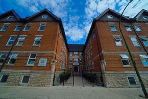 Winnipeg apartment for rent - an old brick building with a blue sky in the background