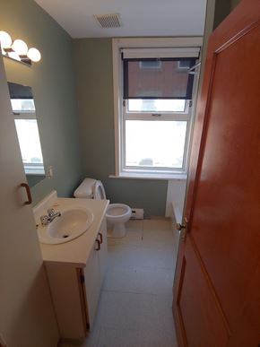 Winnipeg apartment for rent - a bathroom with a toilet and a sink and a window