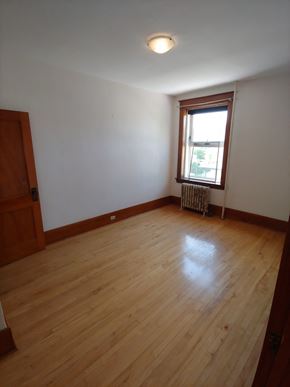 Winnipeg apartment for rent - an empty living room with wooden floors and a window