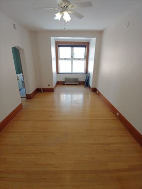 Winnipeg apartment for rent - a room with wooden floors and a window and a ceiling fan