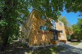 Winnipeg apartment for rent - a yellow house with a tree in front of it